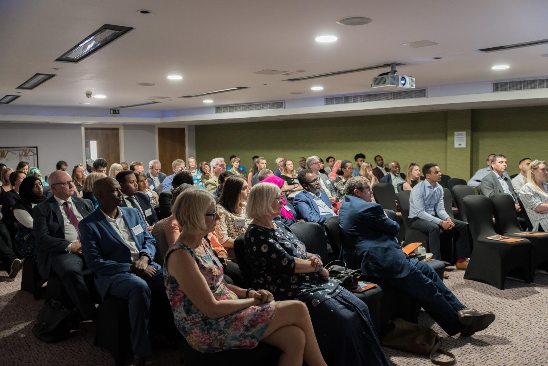crowd at the ACH 10 year event where we spoke about refugees and migrants