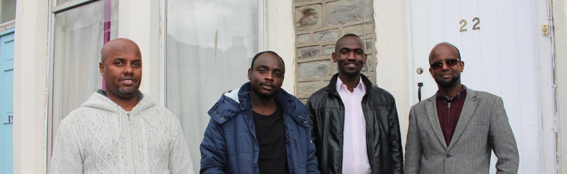 Refugees in front of a home funded by ethical investment