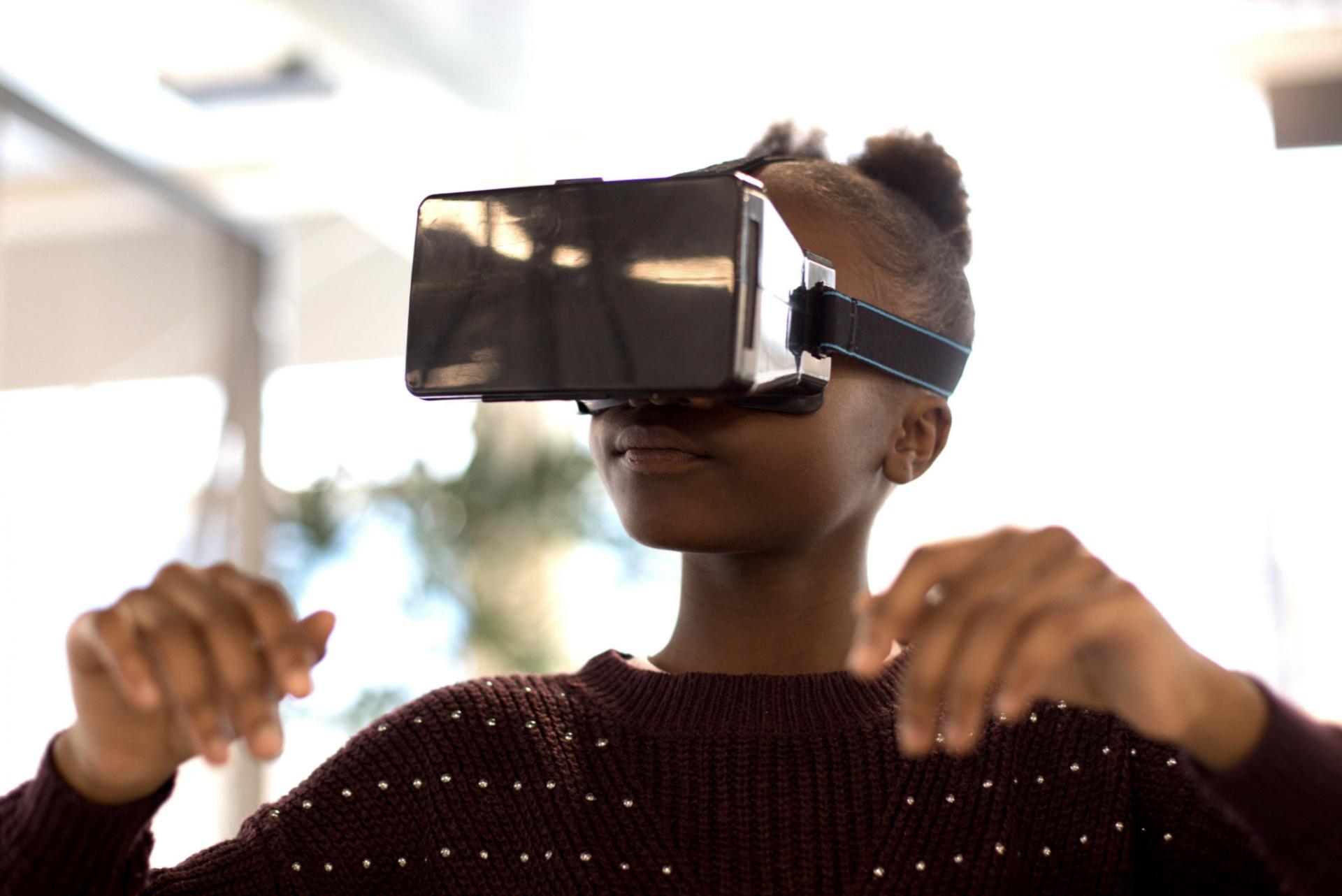 UKBlackTech image of young black girl using virtual reality technology