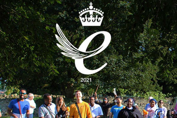 Queens award logo with image of ACH team