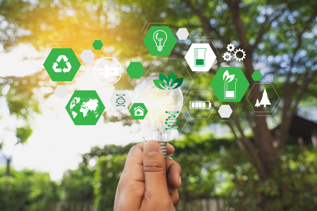 Green background picture with a hand holds a lamp