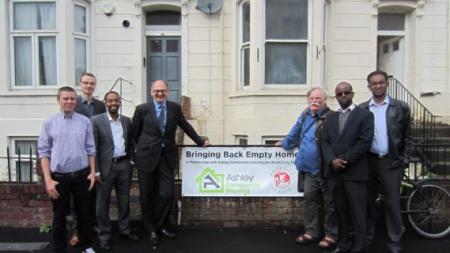 ACH staff posing for a 24housing picture outside a refugee house