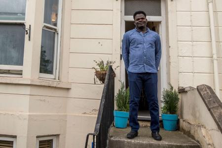 Ahmed Fadul standing outside a migrant and refugee house